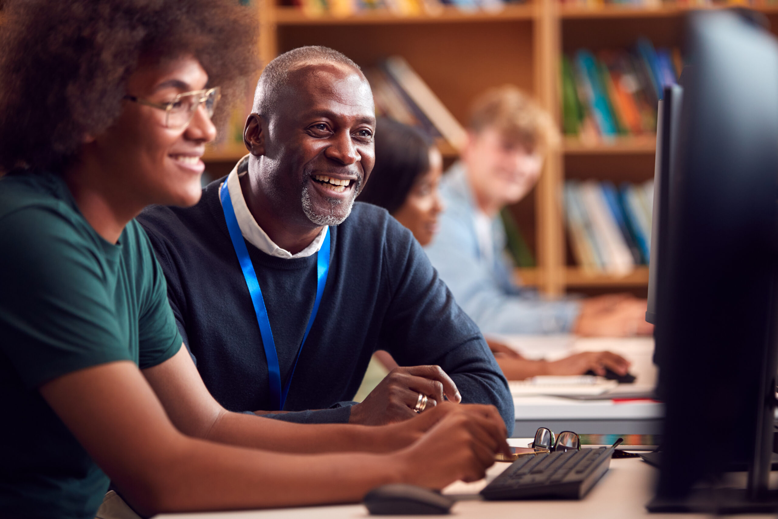 Black man and woman using computer at library