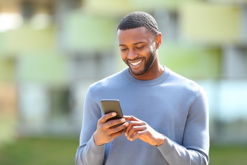 Black man holding smart phone