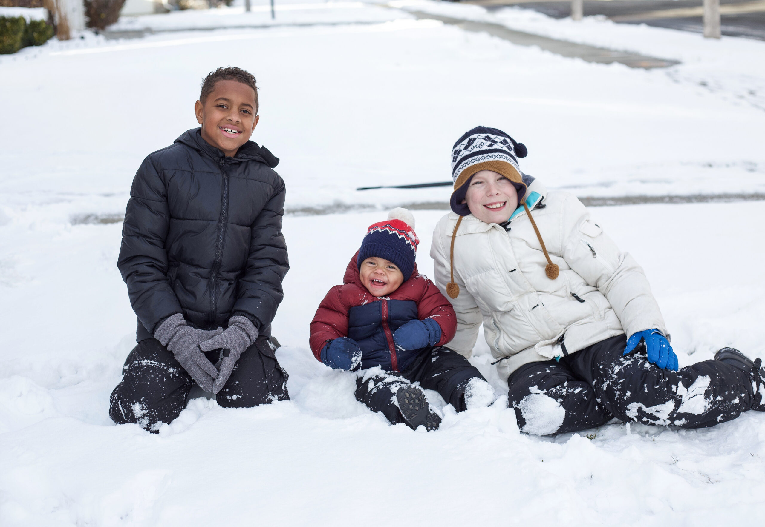 Three children playing in the snow