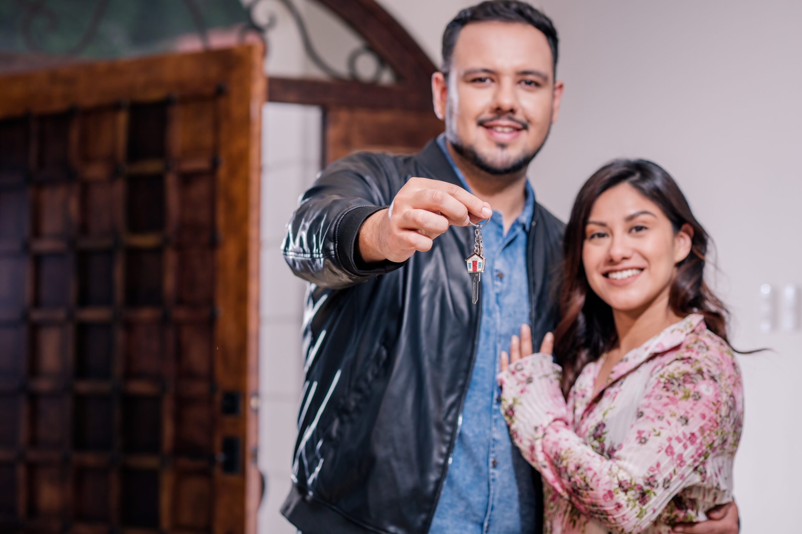 Hispanic couple holding key