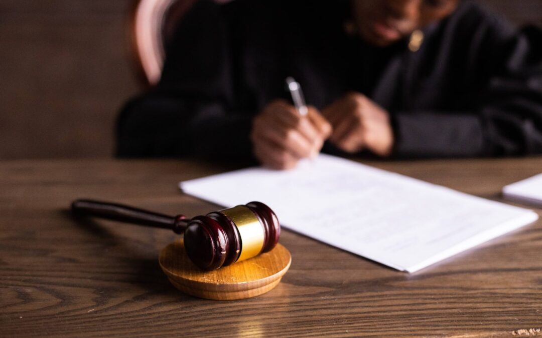 Closeup of gavel with Black female judge in background