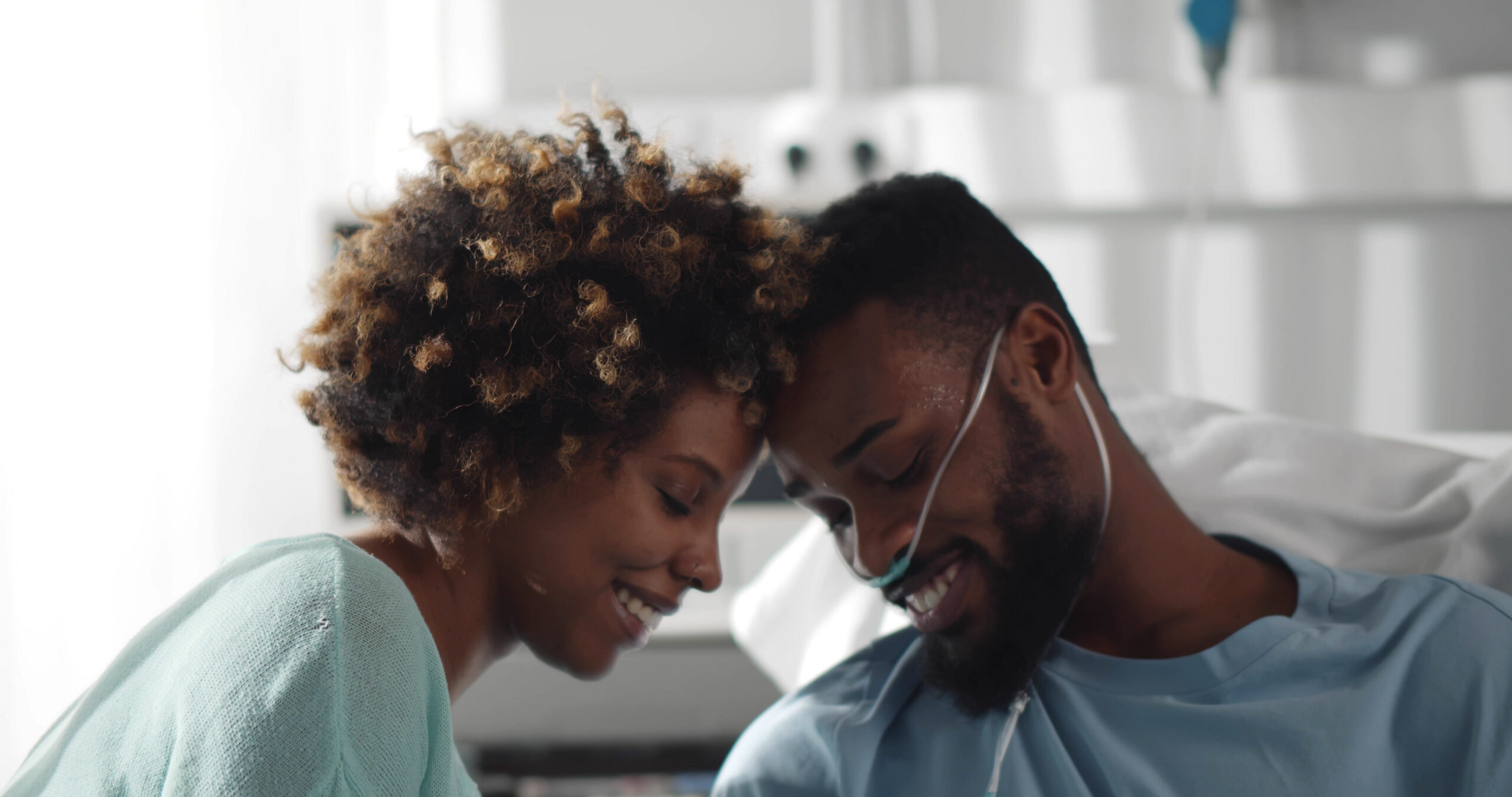 Black woman visiting Black man in hospital