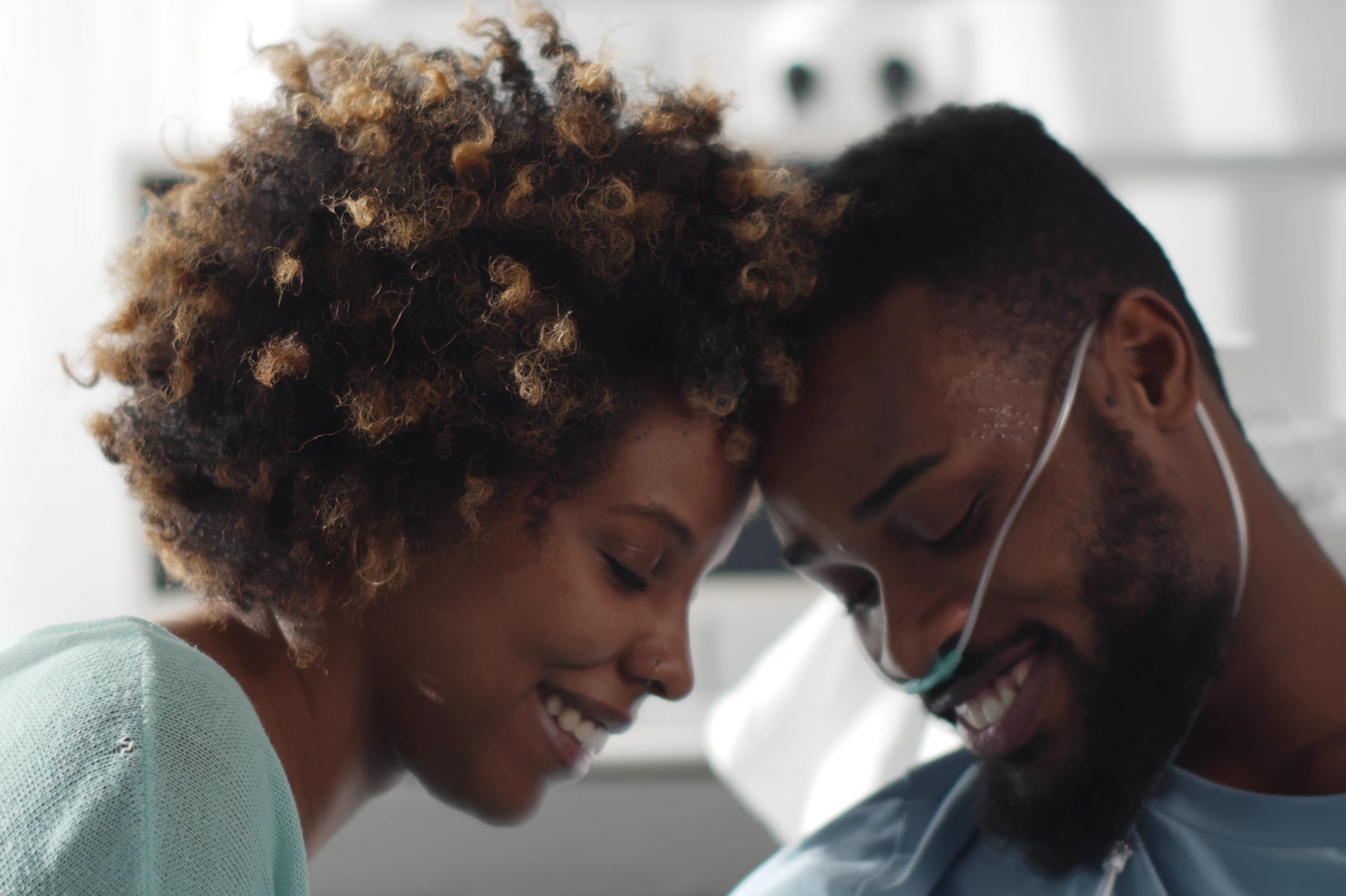 Black woman visiting Black man in hospital